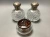 A pair of late Victorian silver mounted cut glass scent bottles, London, 1887, height 13.1 cm and a silver and tortoiseshell powder jar.                                                                                    