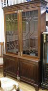 A large mahogany bookcase with double astragal glazed doors and cupboard beneath W.125cm                                               