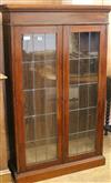 A bookcase with double glazed doors and three shelves W.92cm                                                                           