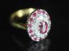 A modern 18ct gold, ruby and diamond set oval cluster ring                                                                                                                                                                  