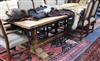 A 17th century style oak refectory table on double turned end supports W.305cm                                                         