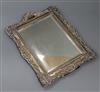 An Edwardian repousse silver mounted easel mirror, Henry Matthews, Birmingham, 1902, 30.2cm.                                           