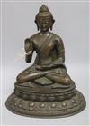 A Nepalese or Tibetan bronze seated model of Buddha                                                                                    