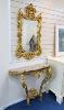 A 19th century rococo revival giltwood console table, 95cm wide, 86.5cm high and a similar later giltwood mirror, 113cm high, 64.5cm wide                                                                                   