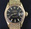 A ladys' 18ct gold Oyster Perpetual Datejust Superlative Chronometer, having black dial with baton numerals (bracelet repaired)        