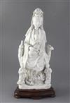 A Chinese Dehua blanc de chine group of Guanyin with child and attendants, 17th/18th century 36cm, height 40cm including wood stand    