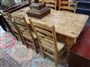 A pine kitchen table and six beech ladderback rush seated chairs W.183cm                                                               