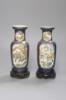 A pair of Chinese Kangxi style blue-ground vases, late 19th century decorated with panels of warriors and heightened in gilt, on carved hardwood stands, height 18cm excluding stand                                        