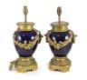 A pair of Louis XVI style ormolu mounted bleu du roi porcelain table lamps, width 23cm height 40cm                                                                                                                          
