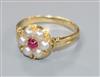 An early 20th century 18ct gold, cabochon ruby and split pearl cluster ring, size M.                                                   