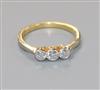 An 18ct gold and three stone diamond ring, size J.                                                                                     