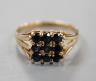 A modern 9ct gold and nine stone sapphire set tablet ring, size R/S, gross weight 2.7 grams.                                                                                                                                