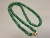 A single strand simulated jade bead necklace with 14k clasp                                                                                                                                                                 