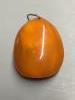 An amber pebble pendant, 56mm, gross weight 29.5 grams.                                                                                                                                                                     