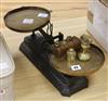 A set of Victorian black painted cast iron scales, with brass pans and weights                                                         