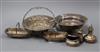 An embossed silver basket, a sterling weighted bowl, a pair of silver 'trug' dishes and three condiments                               