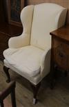 An upholstered wing armchair                                                                                                           