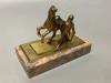 An early 20th century gilt metal group of a horse and jockey, on marble base, length 13cm                                                                                                                                   