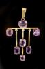 A stylish early 20th century gold and seven stone amethyst set drop pendant                                                                                                                                                 