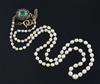 A single strand graduated cultured pearl necklace with emerald cluster set clasp, 50cm.                                                