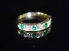 A modern 18ct gold, four stone emerald and three stone diamond set half hoop ring                                                                                                                                           