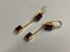 A pair of yellow metal and garnet set drop earrings                                                                                                                                                                         