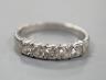 An 18ct white metal and five stone diamond set half hoop ring, size R, gross weight 3.4 grams.                                                                                                                              