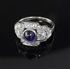 An Art Deco cabochon sapphire and diamond cluster ring, white metal setting (tests as 14ct), size K                                    