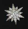 A Victorian gold, silver and old mine and cushion cut diamond set starburst pendant brooch,                                            