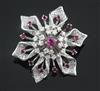 A platinum, ruby and diamond flowerhead brooch, 40mm.                                                                                  