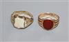 A Victorian 18ct gold and carnelian signet ring and a similar yellow metal ring.                                                       