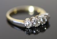 An early 20th century 18ct gold, platinum and graduated four stone diamond ring,                                                       