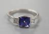 A modern 18ct white gold, single stone tanzanite and two stone diamond set ring, size R, gross weight 5 grams.                                                                                                              