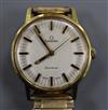 A gentleman's gold plated and steel Omega manual wind wrist watch, on associated flexible strap.                                       