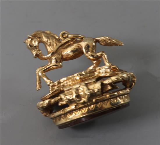 A 9ct gold and carnelian fob surmounted with a horse, 26mm. A 9ct gold and carnelian fob surmounted with a horse, 26mm.