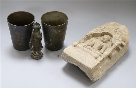 A carved lime stone Indian Stele and an Indian bronze and two Indian beakers carving length 26cm