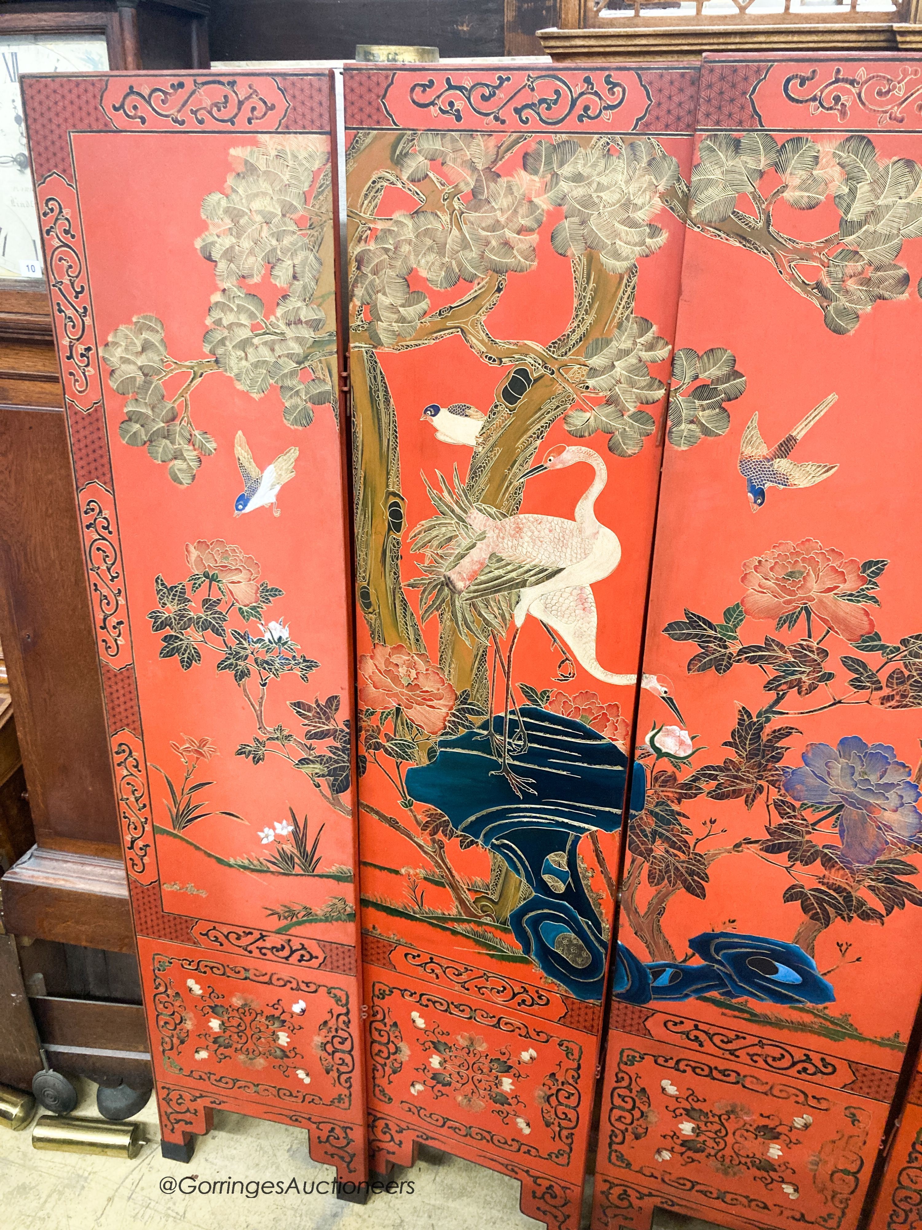 A Chinese red lacquered six fold screen, each panel W.41cm H.184cm
