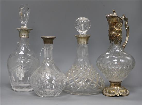 Three cut glass decanters with silver collars (one stopper deficient) and plate-mounted cut glass claret jug Three cut glass decanters with silver collars (one stopper deficient) and plate-mounted cut glass claret jug