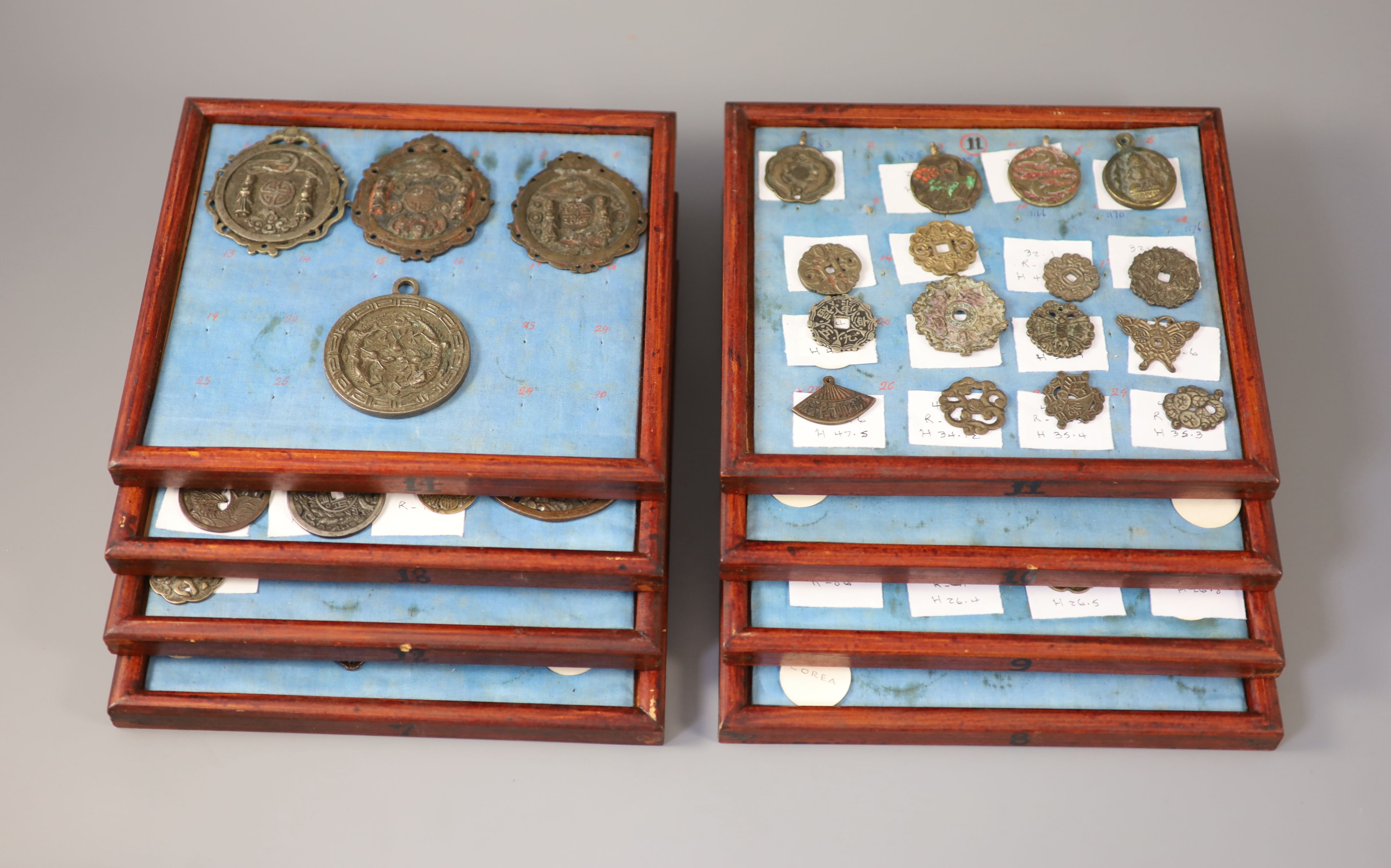 A group of 99 Korean bronze and metal amulets or charms, 19th/20th century A group of 99 Korean bronze and metal amulets or charms, 19th/20th century