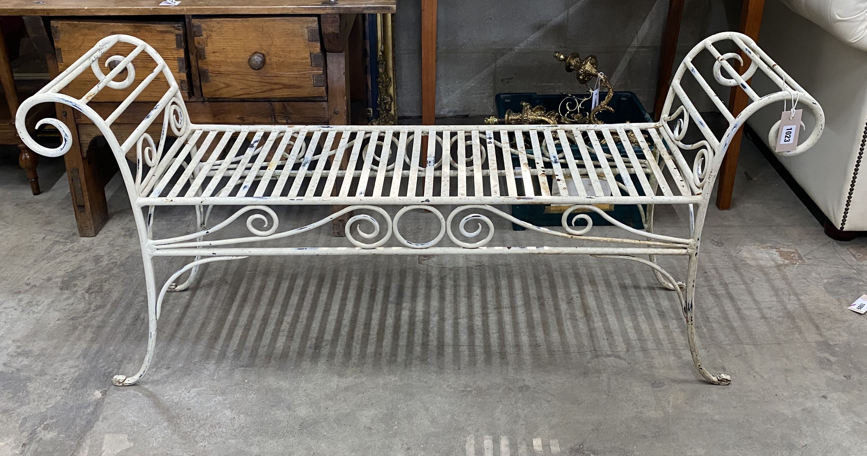 A painted wrought iron scroll end garden bench, length 130cm, depth 34cm, height 61cm