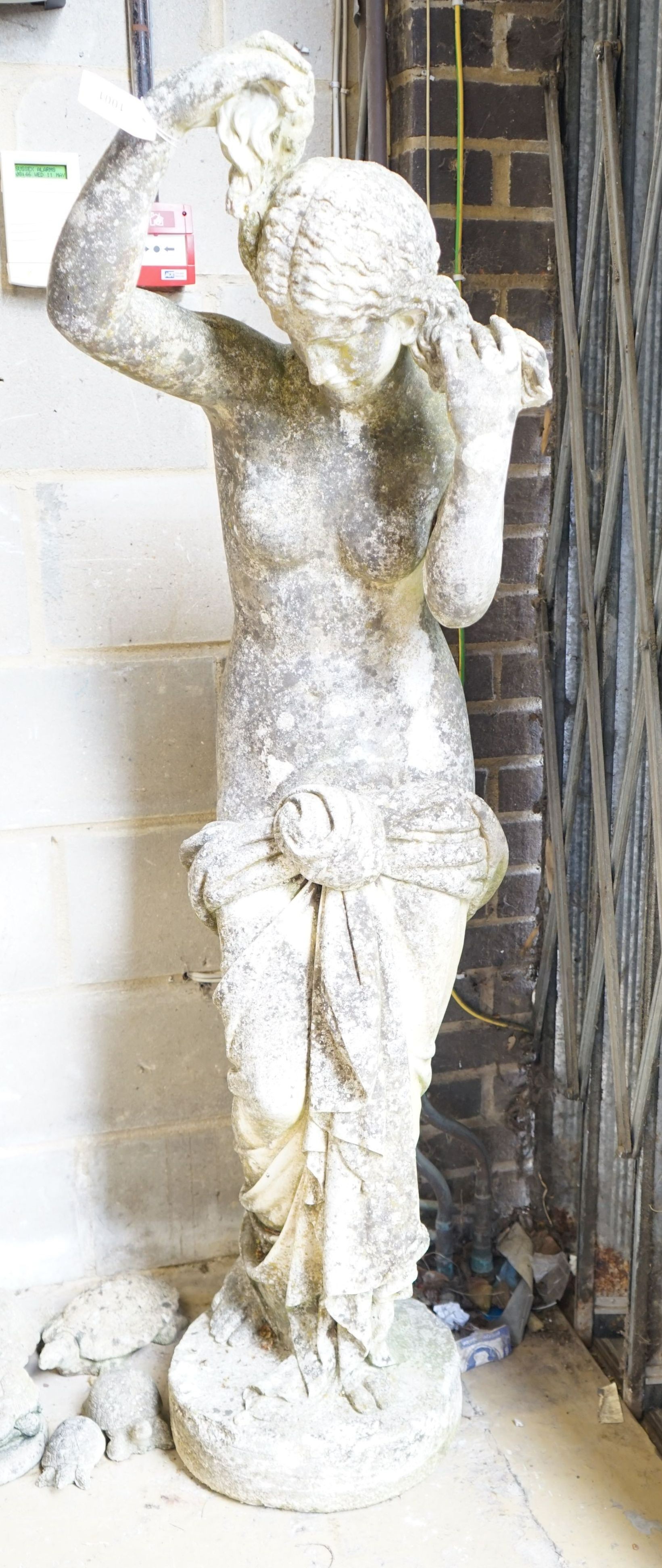 A weathered reconstituted stone garden statue of a robed female figure, height 155cm