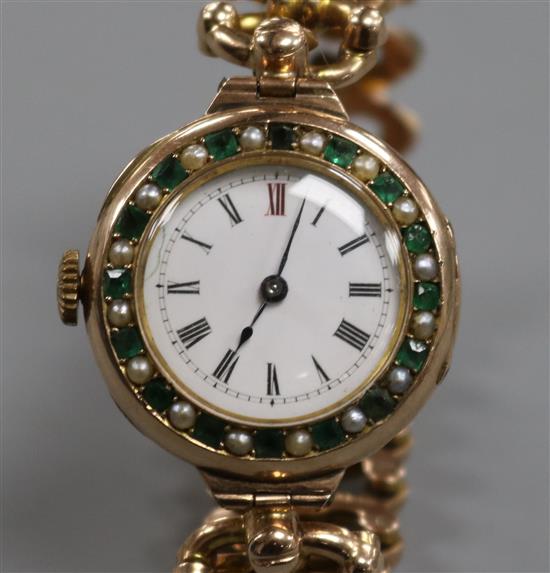 An early 20th century 9ct gold gem set manual wind wrist watch on a 9ct gold expanding bracelet. An early 20th century 9ct gold gem set manual wind wrist watch on a 9ct gold expanding bracelet.