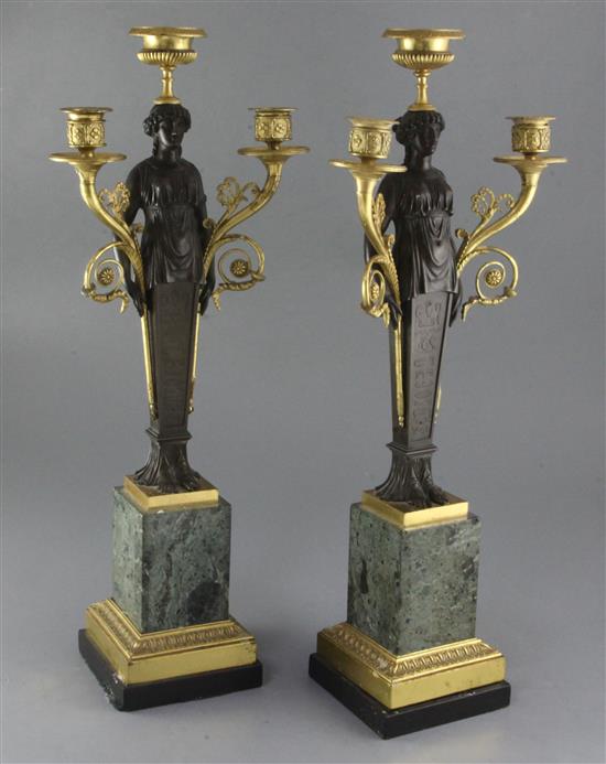 A pair of 19th century French bronze and ormolu three light candelabra, overall height 22in. A pair of 19th century French bronze and ormolu three light candelabra, overall height 22in.