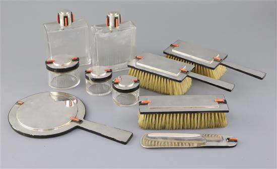 A George V Cartier Ltd Art Deco ten piece silver, coral and black enamel mounted dressing table set, mirror 22.7cm. A George V Cartier Ltd Art Deco ten piece silver, coral and black enamel mounted dressing table set, mirror 22.7cm.
