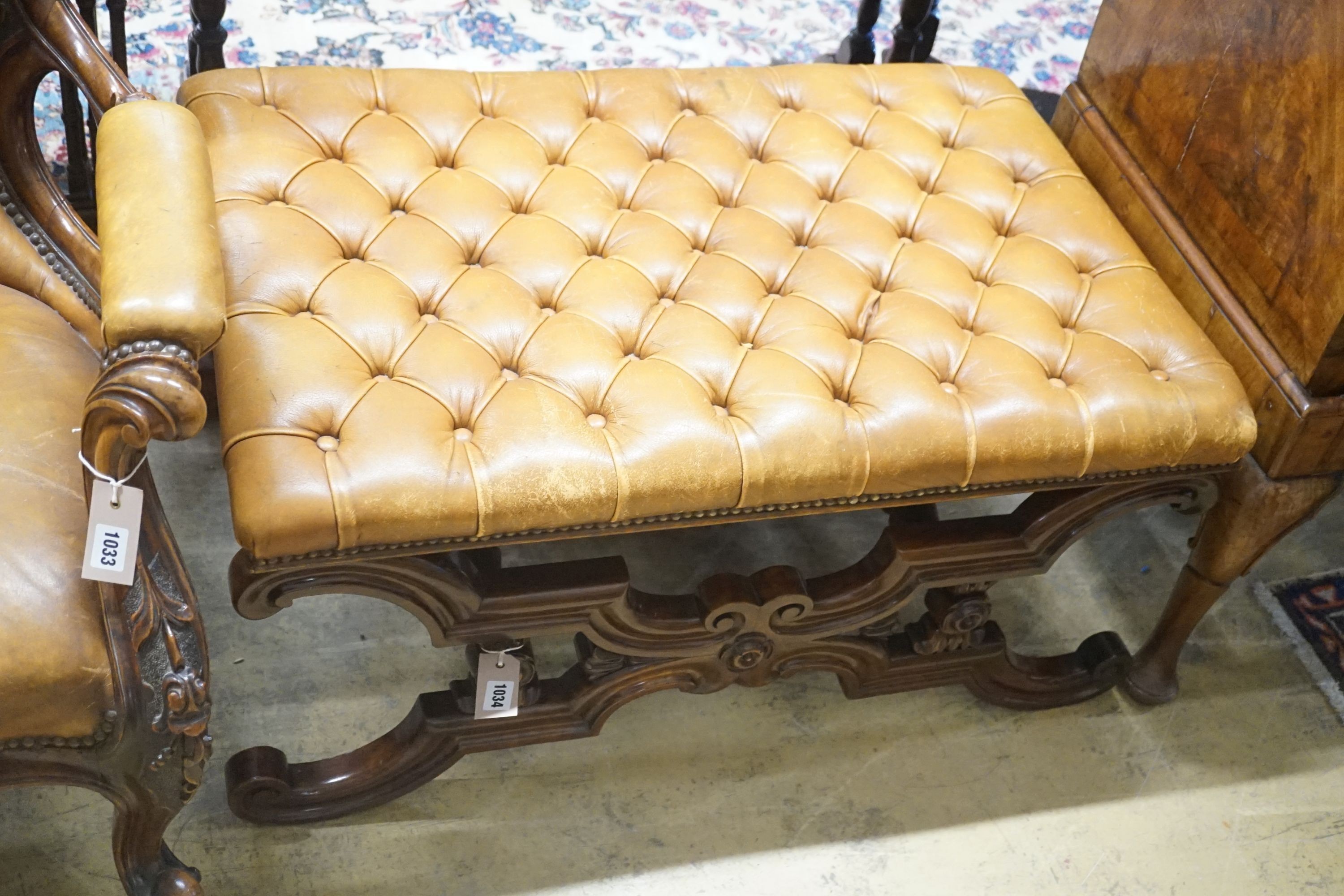 A Victorian carved X-framed rosewood footstool, upholstered in a buttoned brown leather, width 90cm depth 57cm height 42cm