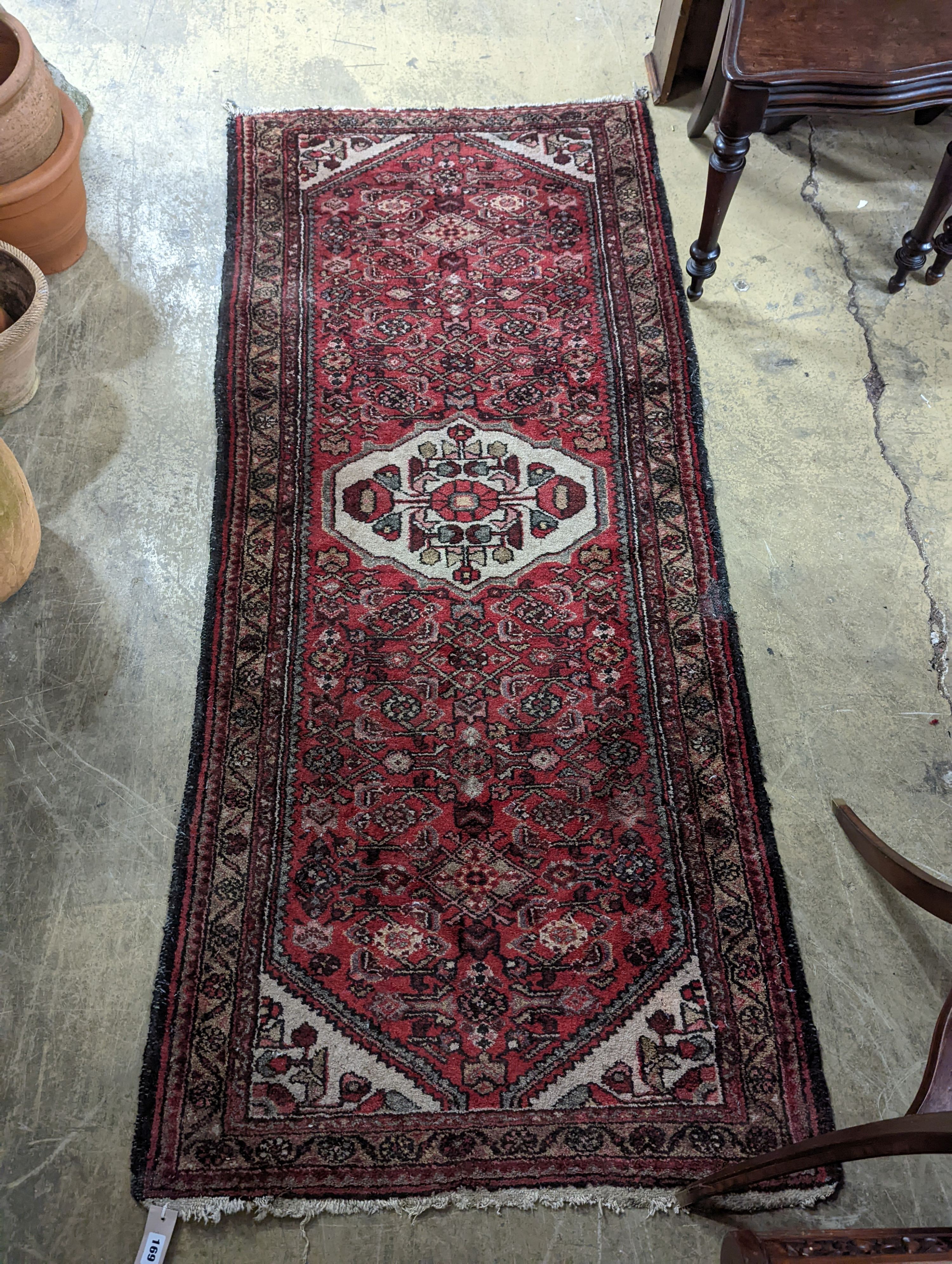 A Hamadan red ground rug, 190 x 82cm