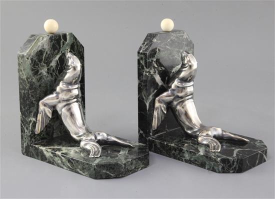 Maurice Frecourt. A pair of Art Deco silvered spelter marble and ivory bookends, 7.5in. Maurice Frecourt. A pair of Art Deco silvered spelter marble and ivory bookends, 7.5in.