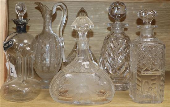 A dimple glass silver-mounted decanter with silver whisky label, a cut glass claret jug and four decanters and stoppers A dimple glass silver-mounted decanter with silver whisky label, a cut glass claret jug and four decanters and stoppers