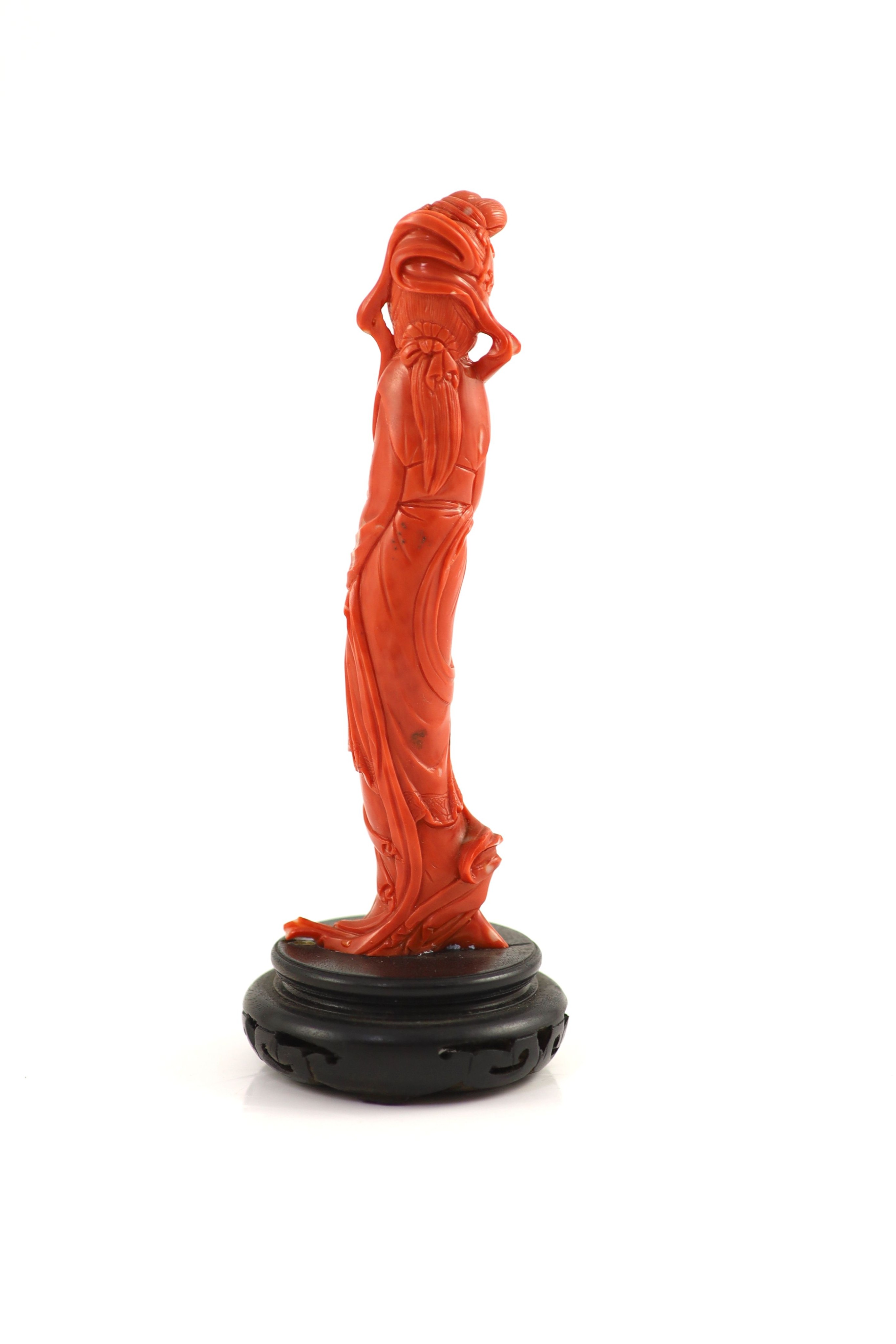 A Chinese coral figure of a tall lady, mid 20th century, 14.7 cm high, 116g, wood stand