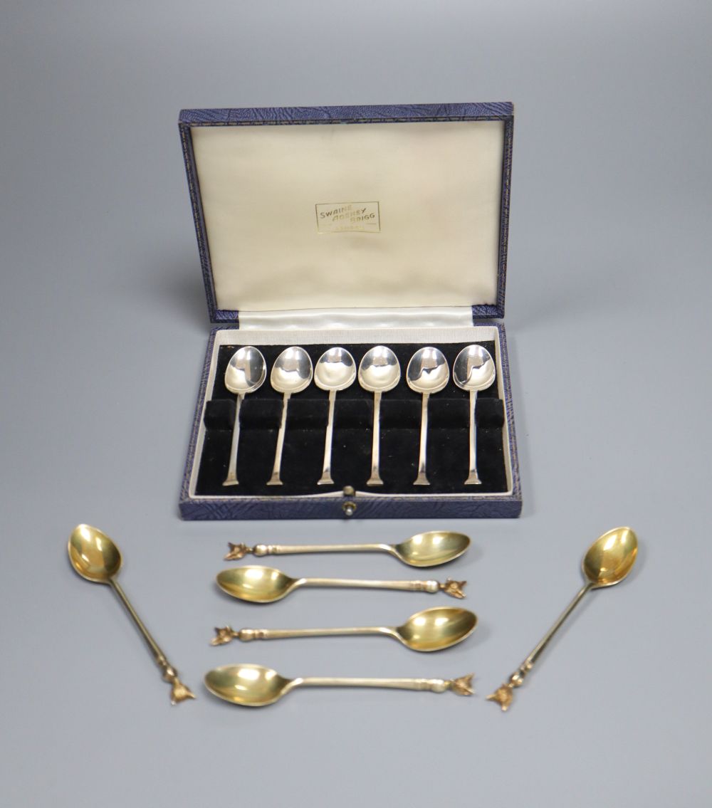 A set of six 1970s silver gilt fox head terminal coffee spoons, 77 grams and a plated set of coffee spoons.